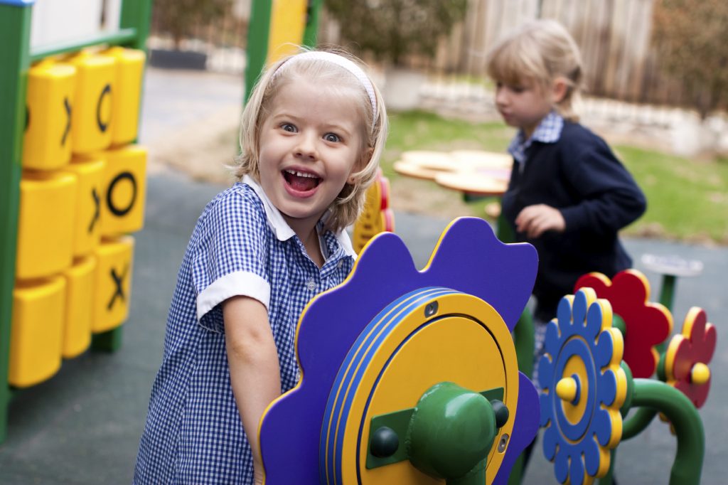 Close-up of a girl playing in a modern, accessible playground